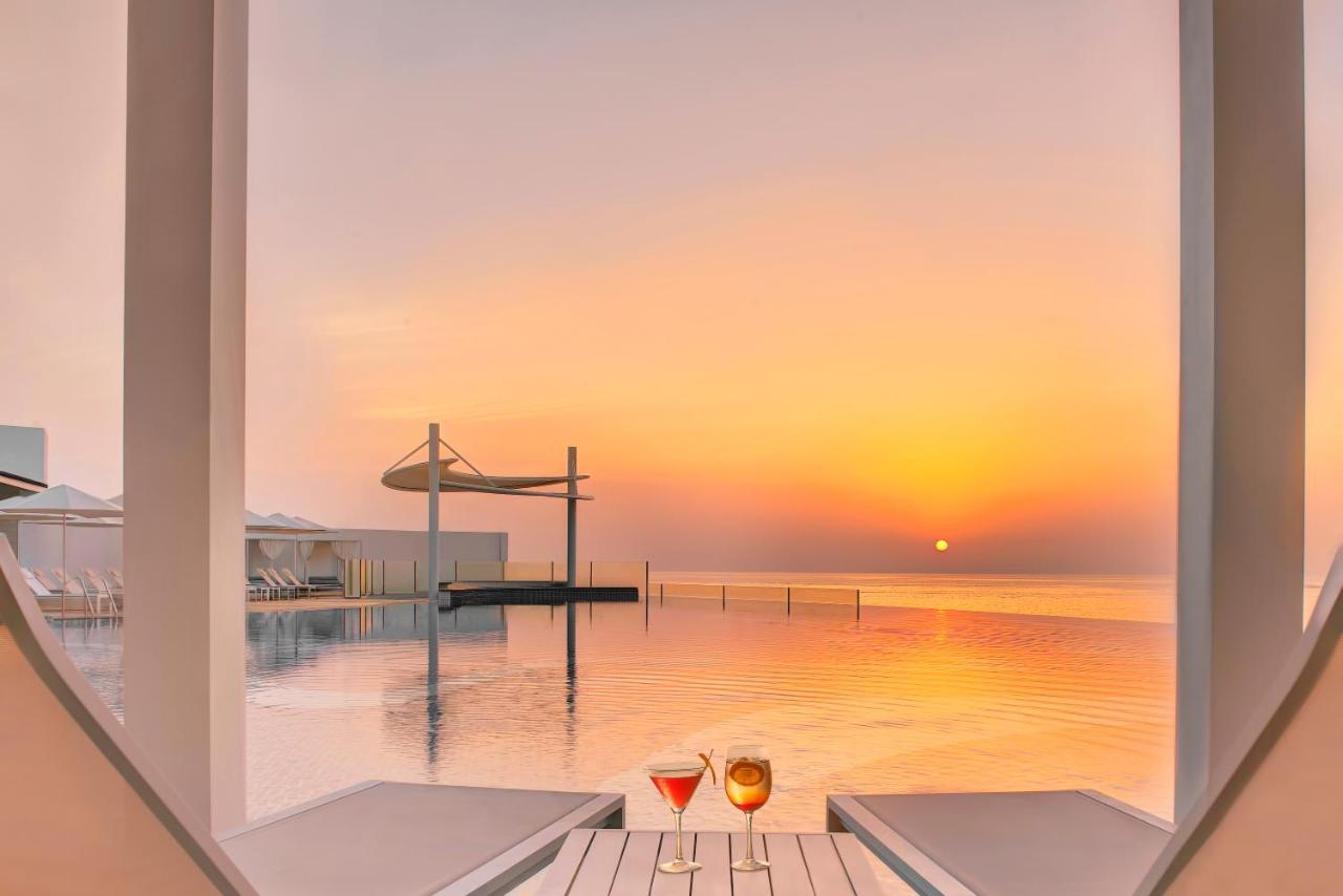 Royal M Al Aqah Beach Resort By Gewan Екстер'єр фото Sunset at the pool
